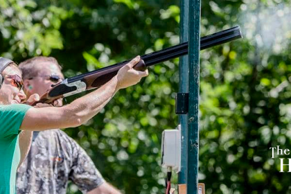 Woman enjoys member benefits at The Highlands Sportsmen's Club learning to shoot with an on-site professional trainer